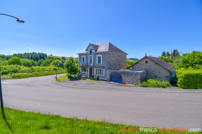Two houses with a wooded park