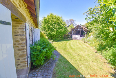Two houses with a wooded park